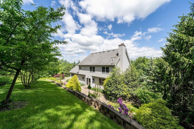57 Terrace Ave, West Orange, NJ 07052 - back of property with a patio area, a lawn, and a chimney