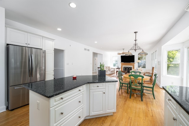 57 Terrace Ave, West Orange, NJ 07052 - kitchen with freestanding refrigerator, a fireplace, light wood-style flooring, recessed lighting, and white cabinetry