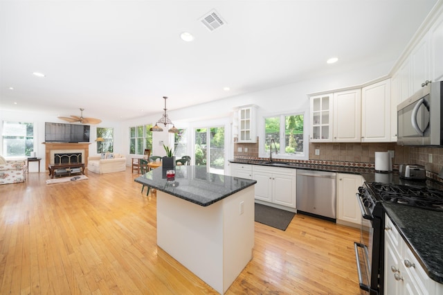 57 Terrace Ave, West Orange, NJ 07052 - kitchen with appliances with stainless steel finishes, a sink, white cabinets, healthy amount of natural light, and recessed lighting