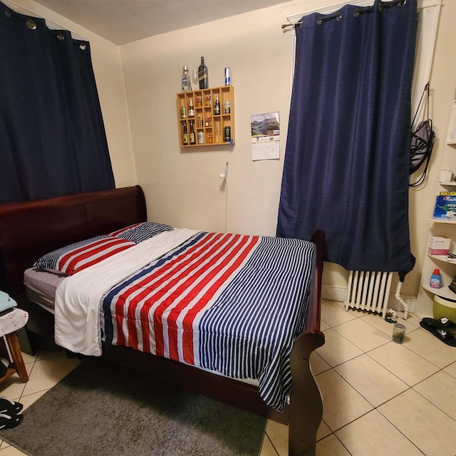 bedroom with tile patterned floors and radiator