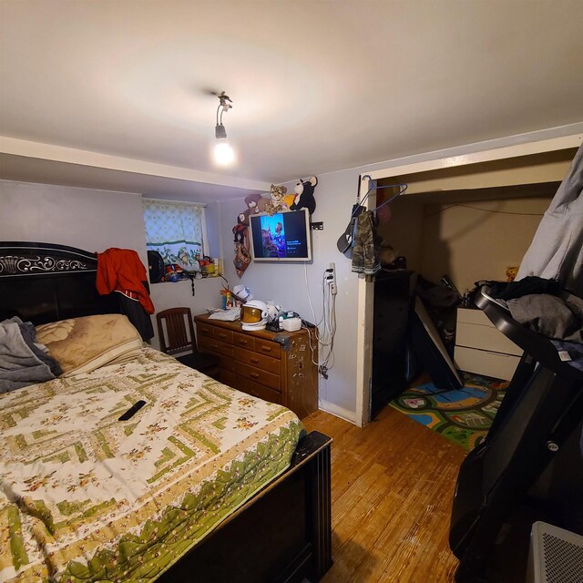 bedroom with hardwood / wood-style floors