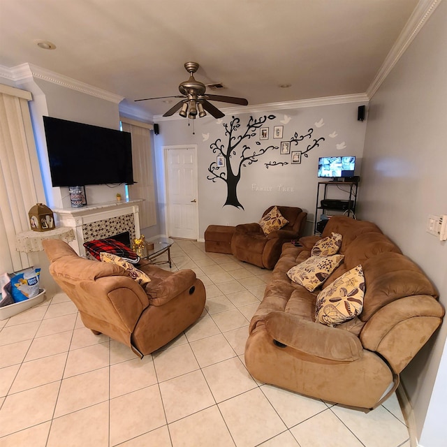 tiled living room featuring a tiled fireplace, ceiling fan, and ornamental molding