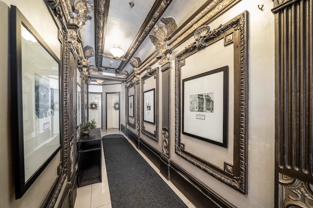 hall featuring light tile patterned floors and crown molding