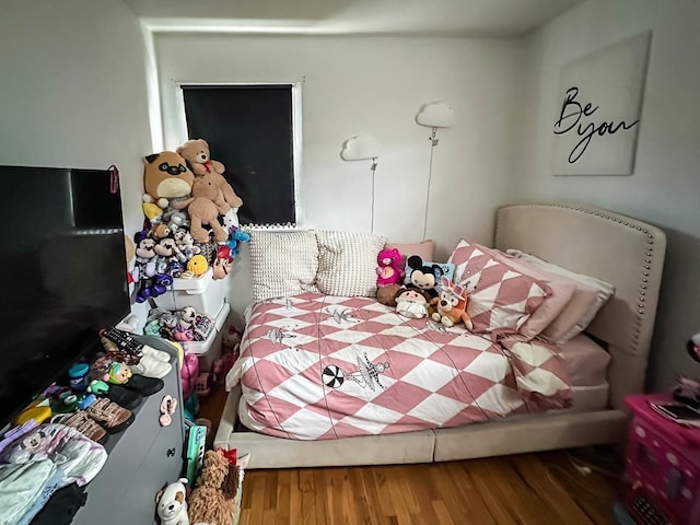 bedroom with wood finished floors