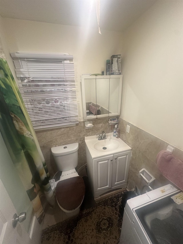 10 Clendenny Ave, Jersey City, NJ 07304 - bathroom featuring wainscoting, toilet, and tile walls