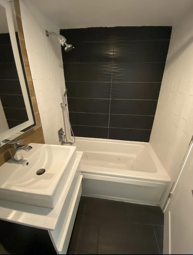 bathroom with tile patterned floors, bathing tub / shower combination, and a sink