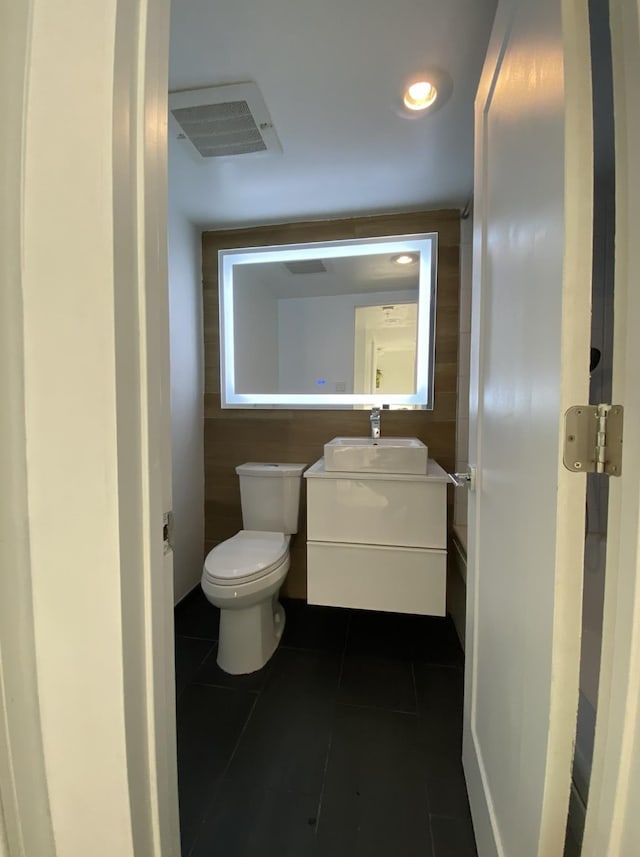 bathroom featuring visible vents, toilet, vanity, and tile patterned flooring