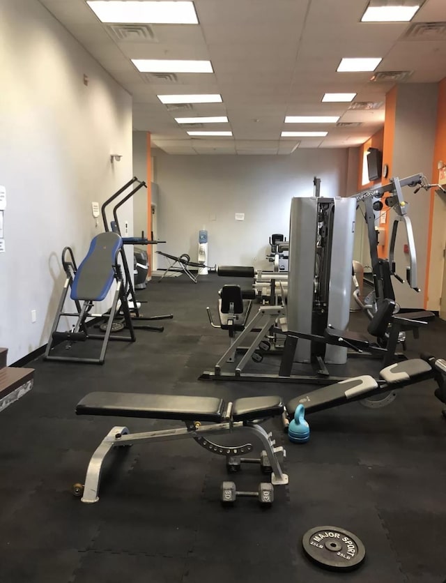 gym featuring a drop ceiling, baseboards, and visible vents