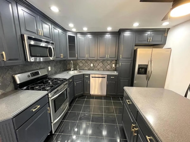 119 W 19th St, Bayonne, NJ 07002 - kitchen with stainless steel appliances, decorative backsplash, light countertops, glass insert cabinets, and recessed lighting