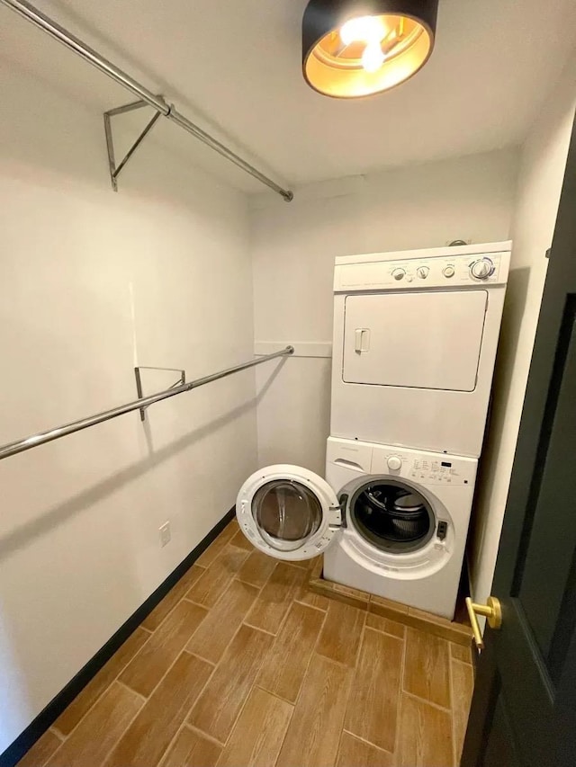 119 W 19th St, Bayonne, NJ 07002 - laundry room with stacked washer and clothes dryer and wood finished floors