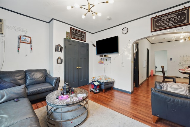119 W 19th St, Bayonne, NJ 07002 - living area with a chandelier, wood finished floors, and arched walkways