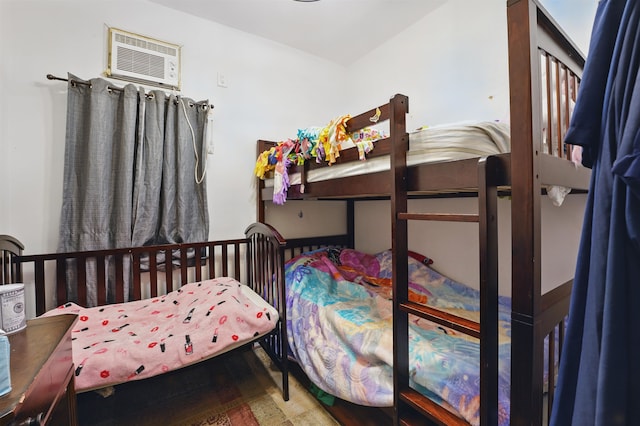 119 W 19th St, Bayonne, NJ 07002 - bedroom with a wall mounted air conditioner and wood finished floors