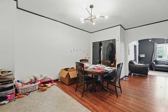 119 W 19th St, Bayonne, NJ 07002 - dining area featuring a chandelier, wood finished floors, and arched walkways
