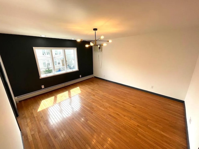 119 W 19th St, Bayonne, NJ 07002 - empty room with hardwood / wood-style flooring, a chandelier, a baseboard heating unit, and a wall mounted AC