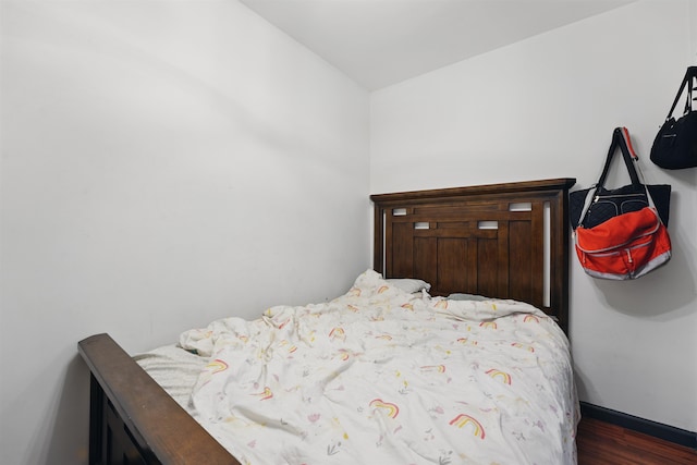119 W 19th St, Bayonne, NJ 07002 - bedroom with dark wood-style floors and baseboards