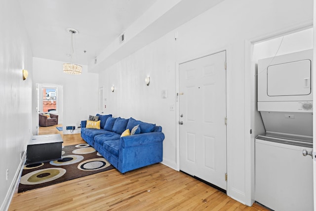 231 Grand St Unit 5R, Hoboken, NJ 07030 - living area with estacked washer and dryer and light wood finished floors