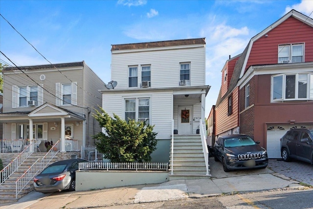 view of front property featuring a garage and a porch