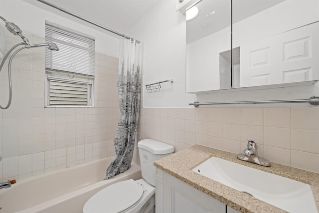 full bathroom with shower / bath combo with shower curtain, vanity, tile walls, and toilet