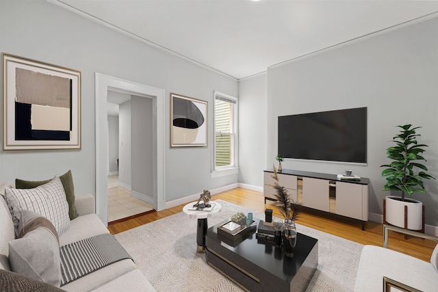 living room featuring light hardwood / wood-style flooring and crown molding