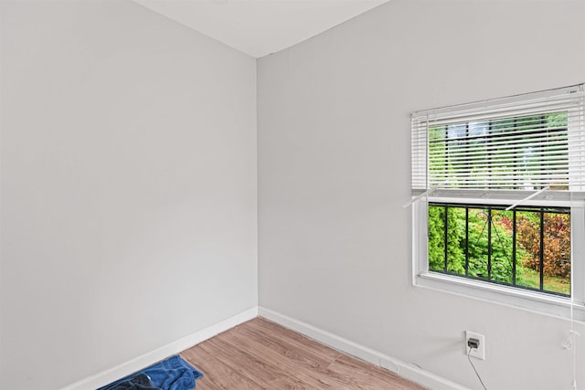 empty room with light hardwood / wood-style flooring