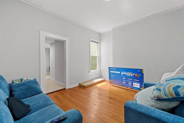 living room with light hardwood / wood-style floors and crown molding