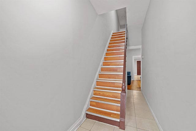 staircase featuring tile patterned floors