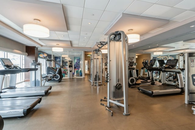 exercise room featuring a paneled ceiling and recessed lighting