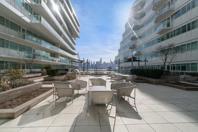 view of home's community featuring a view of city and a patio area