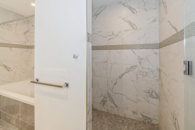 full bath featuring a tub to relax in and tiled shower