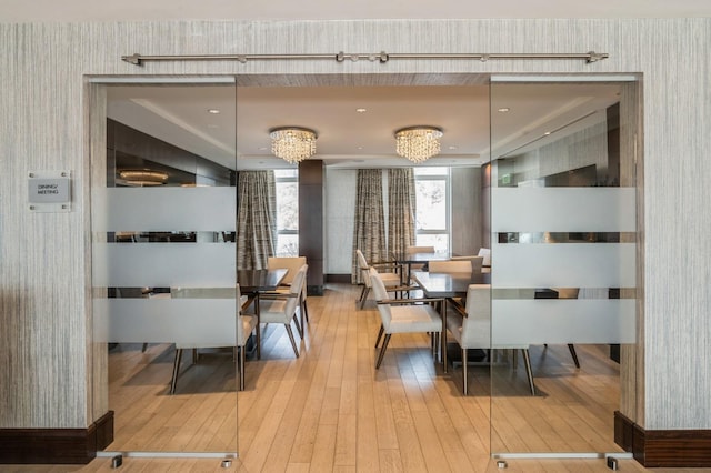 dining room featuring hardwood / wood-style flooring and wallpapered walls