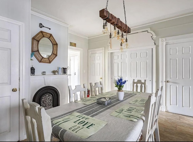 dining space with a fireplace, ornamental molding, and wood finished floors