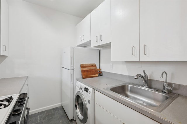 110 Morris St Unit 301, Jersey City, NJ 07302 - kitchen featuring washer / clothes dryer, range with gas stovetop, white cabinetry, fridge, and light countertops