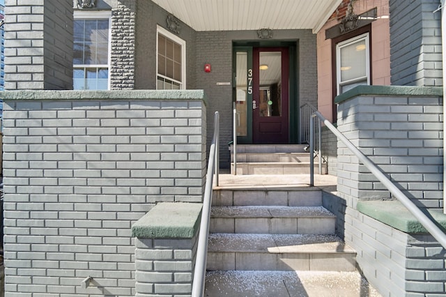 property entrance with brick siding