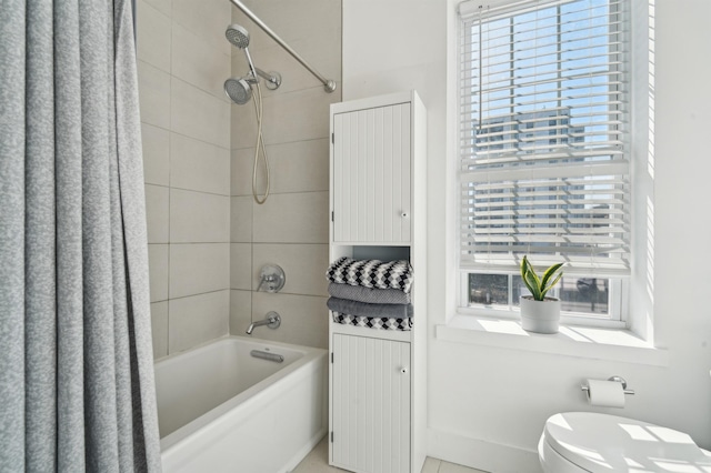 full bathroom featuring a healthy amount of sunlight, toilet, and shower / bath combo with shower curtain