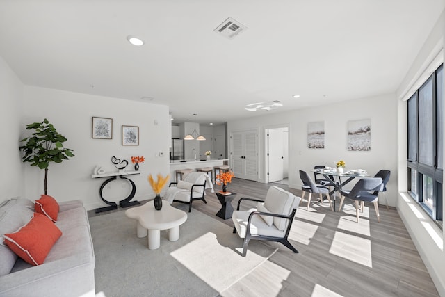 living room with sink and light hardwood / wood-style floors