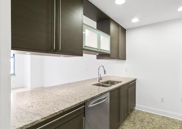 kitchen featuring dark brown cabinets, light stone counters, a sink, recessed lighting, and stainless steel dishwasher