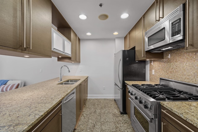 10 Regent St Unit 209X, Jersey City, NJ 07302 - kitchen with appliances with stainless steel finishes, a sink, decorative backsplash, baseboards, and light stone counters