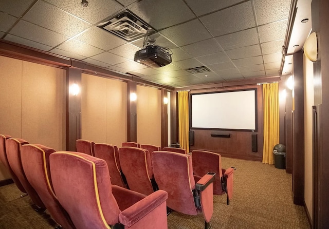 cinema with visible vents, a paneled ceiling, and carpet