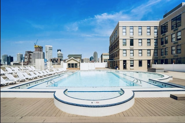 community pool featuring fence and a city view
