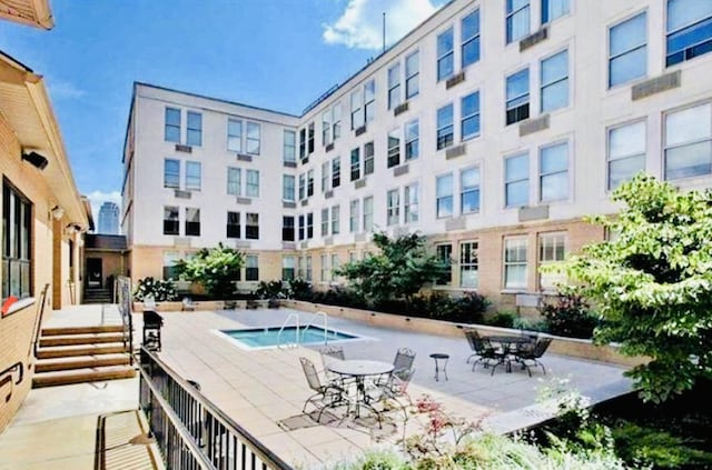 view of pool featuring a hot tub and a patio area
