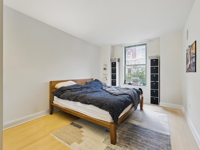 10 Regent St # 308, Jersey City, NJ 07302 - bedroom featuring light wood-style flooring and baseboards