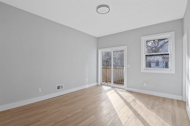 spare room with light hardwood / wood-style flooring