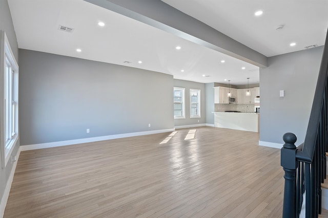 unfurnished living room with light wood-type flooring