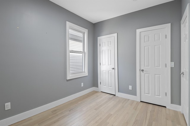 unfurnished bedroom featuring light wood-type flooring