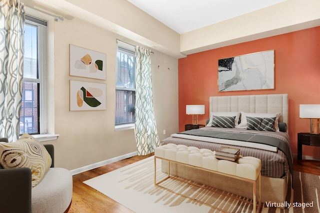 bedroom featuring baseboards and wood finished floors