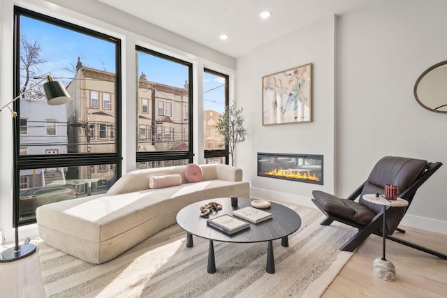 81 Webster Ave Unit 1, Jersey City, NJ 07307 - living area with wood finished floors, a glass covered fireplace, recessed lighting, and baseboards