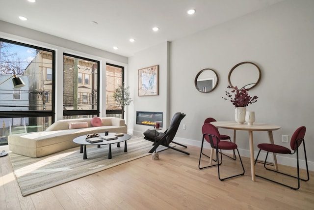 81 Webster Ave Unit 1, Jersey City, NJ 07307 - living area featuring light wood-type flooring, baseboards, recessed lighting, and a glass covered fireplace