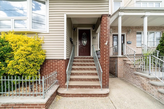 view of exterior entry with covered porch
