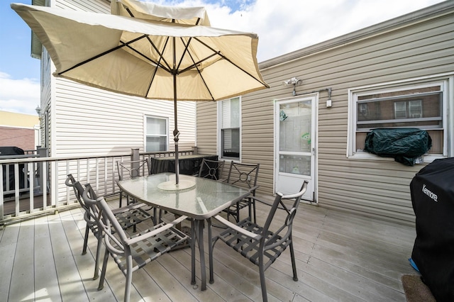 deck featuring grilling area and outdoor dining space