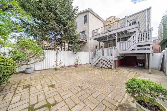 rear view of property featuring fence private yard, a patio area, and stairway